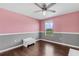 Bright bedroom with wood floors, ceiling fan, and large window at 205 Hamlet Rd, Davenport, FL 33837