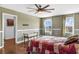 Spacious main bedroom with wood floors, ceiling fan, and access to bathroom at 205 Hamlet Rd, Davenport, FL 33837