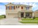 Two-story home with a screened porch and landscaping at 205 Hamlet Rd, Davenport, FL 33837