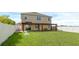Two story house with covered patio, spacious backyard, and white vinyl fence at 205 Hamlet Rd, Davenport, FL 33837