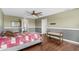 Main bedroom with wood floors, ceiling fan, and access to bathroom at 205 Hamlet Rd, Davenport, FL 33837