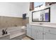 Bathroom with soaking tub and updated vanity at 897 Vicksburg St, Deltona, FL 32725