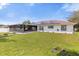 Large backyard with solar panels, screened lanai and firepit at 897 Vicksburg St, Deltona, FL 32725