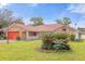 Single-story brick home with a red garage door and landscaped lawn at 897 Vicksburg St, Deltona, FL 32725