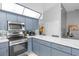 Modern kitchen with stainless steel appliances and blue cabinets at 897 Vicksburg St, Deltona, FL 32725