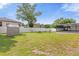 Large grassy backyard with shed and screened patio at 897 Vicksburg St, Deltona, FL 32725
