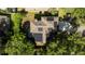 Aerial view of a house with solar panels on the roof, nestled among trees at 1509 Red Oak Ct, Apopka, FL 32703