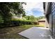 Small backyard with a patio and privacy hedge at 1509 Red Oak Ct, Apopka, FL 32703