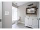 Modern bathroom with white vanity, large mirror, and updated fixtures at 1509 Red Oak Ct, Apopka, FL 32703