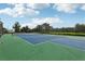 Well-maintained tennis court with green surface at 16838 Glenbrook Blvd, Clermont, FL 34714