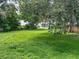 Large grassy backyard with mature trees at 1129 Crestview Ave, Lakeland, FL 33805