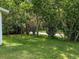 Spacious backyard with lush greenery and a chain link fence at 1129 Crestview Ave, Lakeland, FL 33805