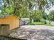 Detached yellow garage with ample concrete parking area at 1129 Crestview Ave, Lakeland, FL 33805