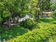 Large backyard with mature trees and a partially paved patio area at 1129 Crestview Ave, Lakeland, FL 33805