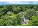 Aerial view showing a home and surrounding neighborhood with lush green trees at 1129 Crestview Ave, Lakeland, FL 33805