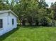 Side view of a white house and yard at 1129 Crestview Ave, Lakeland, FL 33805
