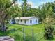 White house exterior with chain link fence at 1129 Crestview Ave, Lakeland, FL 33805