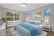 Virtually staged bedroom featuring light blue bedding and natural light at 610 20Th Sw St, Winter Haven, FL 33880