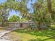 Tan single story home with a driveway and landscaping at 610 20Th Sw St, Winter Haven, FL 33880