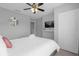 King-size bed, TV, and ample closet space in this bedroom at 2213 San Vittorino Cir # 106, Kissimmee, FL 34741