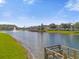 Serene pond with a wooden dock and fountain at 2213 San Vittorino Cir # 106, Kissimmee, FL 34741