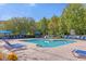 Community pool with blue lounge chairs and umbrellas at 2213 San Vittorino Cir # 106, Kissimmee, FL 34741