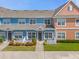 Two-story townhouses with a charming white picket fence and colorful landscaping at 2213 San Vittorino Cir # 106, Kissimmee, FL 34741
