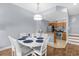 Bright dining area with a white table and chairs, adjacent to a modern kitchen at 2213 San Vittorino Cir # 106, Kissimmee, FL 34741