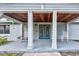 Inviting front porch with rocking chairs and double doors at 8342 Starr Dr, Orlando, FL 32818