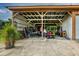 Open-air garage or carport with various items stored inside at 8342 Starr Dr, Orlando, FL 32818