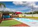 Inviting pool area with deck, tiki bar, and lush landscaping at 8342 Starr Dr, Orlando, FL 32818