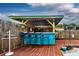 Tropical-themed tiki bar with seating for four on a deck at 8342 Starr Dr, Orlando, FL 32818