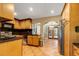 Open kitchen with wood cabinets, granite countertops and view to backyard at 8342 Starr Dr, Orlando, FL 32818