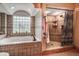 Bathroom with soaking tub, walk-in shower, and double sinks at 8342 Starr Dr, Orlando, FL 32818