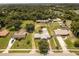 Aerial view showing multiple houses, lush green landscape, and a tranquil lake nearby at 8342 Starr Dr, Orlando, FL 32818