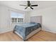 Spacious bedroom with ceiling fan and large window at 14037 Fairway Island Dr # 233, Orlando, FL 32837