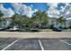 Exterior view of condo building with ample parking at 14037 Fairway Island Dr # 233, Orlando, FL 32837