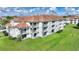 Aerial view of condo building showcasing landscaping and parking at 14037 Fairway Island Dr # 233, Orlando, FL 32837