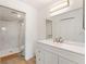 Clean bathroom with a walk-in shower, white vanity, and marble tile at 14037 Fairway Island Dr # 233, Orlando, FL 32837