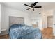 Bright bedroom with a queen bed, built-in shelving, and ceiling fan at 14037 Fairway Island Dr # 233, Orlando, FL 32837