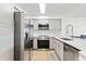 Modern kitchen with stainless steel appliances and light gray cabinets at 14037 Fairway Island Dr # 233, Orlando, FL 32837