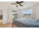 Bedroom with a queen bed, balcony access, and large window at 14037 Fairway Island Dr # 233, Orlando, FL 32837