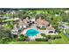 Community pool area with surrounding landscaping and clubhouse at 14037 Fairway Island Dr # 233, Orlando, FL 32837