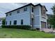 Side view of a two-story townhome, showcasing its stone and stucco exterior at 8502 Arcadia Ln, Davenport, FL 33896