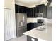 Modern kitchen with dark cabinets, stainless steel appliances, and quartz countertops at 8502 Arcadia Ln, Davenport, FL 33896