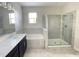 Main bathroom with double vanity, soaking tub, and glass shower at 8502 Arcadia Ln, Davenport, FL 33896