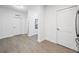 Light and bright hallway with wood-look flooring and neutral walls at 14501 Grove Resort Ave # 3137, Winter Garden, FL 34787