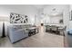 Open concept living room and dining area with gray sectional sofa at 14501 Grove Resort Ave # 3137, Winter Garden, FL 34787