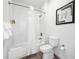 Clean bathroom with a shower/tub combo and white tile at 14501 Grove Resort Ave # 3137, Winter Garden, FL 34787