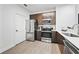 Modern kitchen with stainless steel appliances and wood-look flooring at 14501 Grove Resort Ave # 3137, Winter Garden, FL 34787